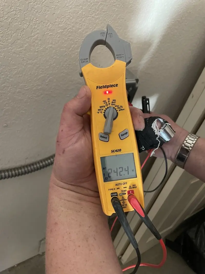 Voltage testing with clamp meter during Recessed Lighting Installation in Port Vue